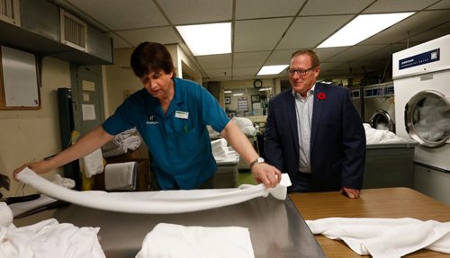 WAYNE GLOWACKI / WINNIPEG FREE PRESS


At left, Gregg Cooke, the Houseman at the Holiday Inn Winnipeg-Airport West gives a tour of his duties to Scott Fielding, MLA and Minister responsible for disabilities as part Take a MLA to Work Day. Greg who has a cognitive disability shows Scott the art of folding a towel in  the laundry area. This is an event where local disability groups take MLAs to various work places to see adults with disabilities working.     Kevin Rollason   story Oct. 28 2016