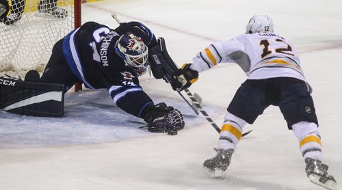 MIKE DEAL / WINNIPEG FREE PRESS
The Winnipeg Jets' goaltender Michael Hutchinson (34) tries to stop the puck while Buffalo Sabres' forward Brian Gionta (#12) goes in to slap it into the net during NHL game action Sunday afternoon at the MTS Centre.
161030 - Sunday October 30, 2016
