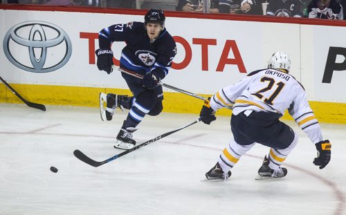 MIKE DEAL / WINNIPEG FREE PRESS
The Winnipeg Jets' Nikolaj Ehlers (27) passes the puck past Buffalo Sabres' forward Kyle Okposo (#21) during NHL game action Sunday afternoon at the MTS Centre.
161030 - Sunday October 30, 2016