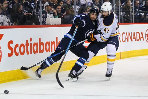 MIKE DEAL / WINNIPEG FREE PRESS
The Winnipeg Jets' Alexander Burmistrov (91) tries to keep the puck while being checked by Buffalo Sabres' defenceman Zach Bogosian (#47) during NHL game action Sunday afternoon at the MTS Centre.
161030 - Sunday October 30, 2016