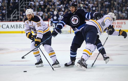 MIKE DEAL / WINNIPEG FREE PRESS
The Winnipeg Jets' Alexander Burmistrov (91) is forced off the puck by Buffalo Sabres' defenceman Jake McCabe (#29) while Sabres' forward Ryan O'Reilly (#90) picks it up during NHL game action Sunday afternoon at the MTS Centre.
161030 - Sunday October 30, 2016