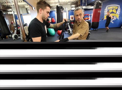 PHIL HOSSACK / WINNIPEG FREE PRESS -  Trainer Braden Pyper (left) tapes Tadashi Orui prepping for "Counter Punch" a boxing program for Parkinson's patients. See Jeff Hamilton's story.  November 1, 2016