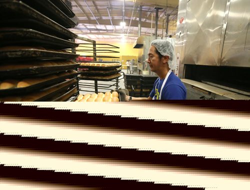 JASON HALSTEAD / WINNIPEG FREE PRESS

Employee Rodrigo Lim places buns on cooling racks at KUB Bakery on Erin Street in the West End on Nov. 2, 2016. KUB Bakery has been making Winnipeg-style Rye bread, using virtually the same recipe, since 1923. (See Sanderson The City story for Sunday, Nov. 6, 2016)