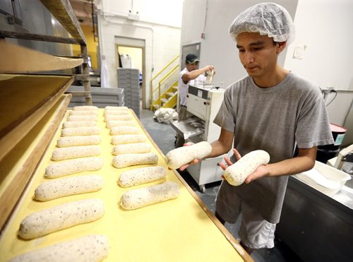 JASON HALSTEAD / WINNIPEG FREE PRESS

Employees Justin Ross (right) and Welfredo Yamoung prepare loaves of rye at KUB Bakery on Erin Street in the West End on Nov. 2, 2016. KUB Bakery has been making Winnipeg-style Rye bread, using virtually the same recipe, since 1923. (See Sanderson The City story for Sunday, Nov. 6, 2016)