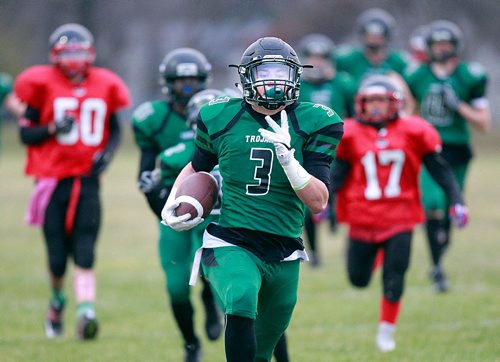 PHIL HOSSACK / WINNIPEG FREE PRESS - Vincent Massey #3 Brock Cavanagh runs through and past traffic to score his team's third TD in the 2nd quarter Wednesday. The lopsided game was 35-0 for Vincent Massey at the half. See Jason Bell's story.  November 2, 2016