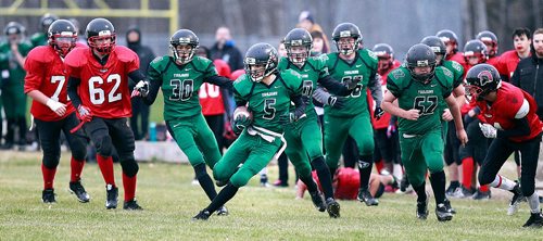 PHIL HOSSACK / WINNIPEG FREE PRESS - Vincent Massey #5 Teagan Simon runs through and past traffic after intercepting a Sisler Trojan pass late in the first quarter Wednesday. The lopsided game was 35-0 for Vincent Massey at the half. See Jason Bell's story.  November 2, 2016