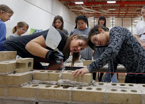 WAYNE GLOWACKI / WINNIPEG FREE PRESS





At right, Scarlett Penner a student at Prince Edward School learns about bricklaying from Nina Widmer, from Alpha Masonry Friday morning during the Unlocking the Toolkit Girls Forum held at Bernie Wolfe School. Sixty-two grade 5 girls from the school division were invited to take part in the workshop in the gym to get hands on experience in different trades including carpentry, plumber/pipe fitting and virtual reality game developing. see release Nov. 4 2016
