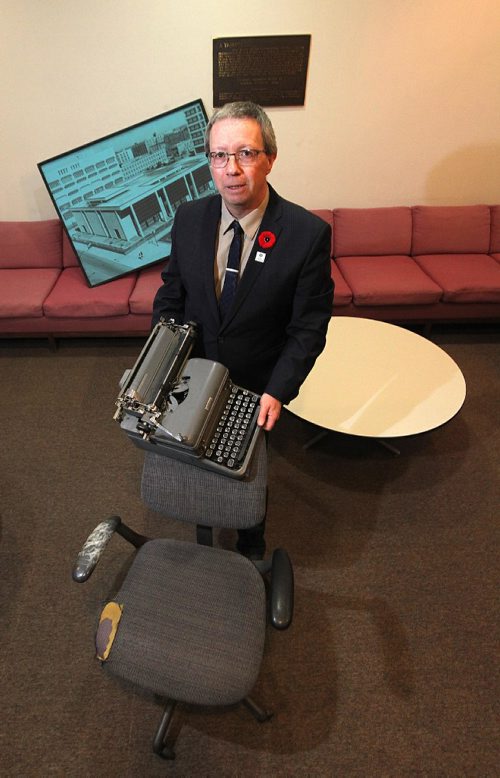PHIL HOSSACK / WINNIPEG FREE PRESS -  Aldo Santin, long time city hall reporter (Since the 1980's he says) poses holding some of the accumulated trash that has accumulated in the City Hall "media room", including an old manual typewriter. The area is going to be turned into a modern media cpnference room. See Aldo's story. November 4, 2016