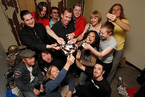 BORIS MINKEVICH / WINNIPEG FREE PRESS  080608 5th anniversary of Transistor 66 Records. Art MacIntyre (middle in black) holds a festive cake that the label's artists dig into.