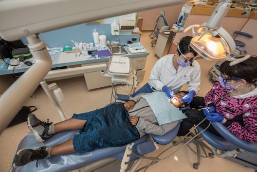 DAVID LIPNOWSKI / WINNIPEG FREE PRESS 

Dr. Karina Gamboa (left) and Dr. Carla Cohn (right) work on Mwashite Mbekalo of Tanzania at the University of Manitoba's College of Dentistry Saturday November 5, 2016. The Manitoba Dental Association and the University of Manitoba's College of Dentistry hosted OPEN WIDE, a day of free dental services for refugees.