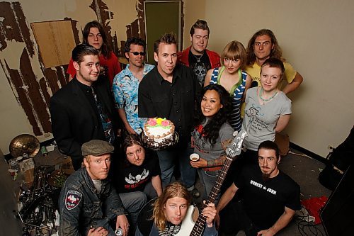 BORIS MINKEVICH / WINNIPEG FREE PRESS  080608 5th anniversary of Transistor 66 Records. Art MacIntyre (middle in black) holds a festive cake that the label's artists dig into.