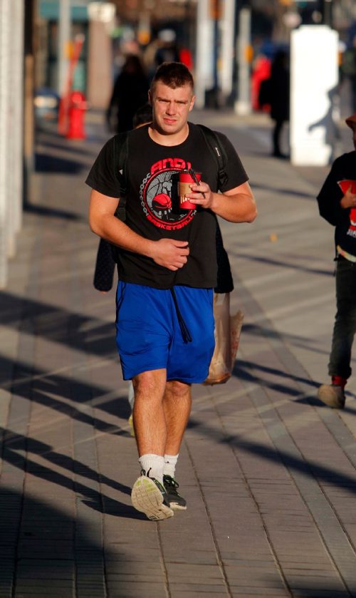 BORIS MINKEVICH / WINNIPEG FREE PRESS
University of Winnipeg volleyball player Nolan Parrington keeps in his shorts on while he enjoys the sunshine on Portage Ave near the University. He just came back from Vancouver for sports and said the weather here is way nicer than the west coast right now. November 7, 2016