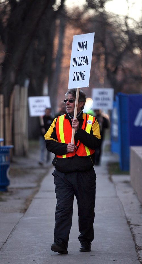 PHIL HOSSACK / WINNIPEG FREE PRESS - UMFA picketers march along McDermot ave beside the Bannatyne Campus at the Health Sciences Center Monday afternoon as the union and U of M administration continue to negotiate.  With the strike in it's 2nd week the picket line here is not blocking or delaying vehicular traffic or pedestrian, just seems to be maintaining a visible presence. See story.  November 7, 2016