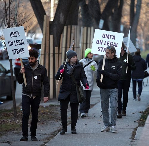 PHIL HOSSACK / WINNIPEG FREE PRESS - UMFA picketers march along McDermot ave beside the Bannatyne Campus at the Health Sciences Center Monday afternoon as the union and U of M administration continue to negotiate.  With the strike in it's 2nd week the picket line here is not blocking or delaying vehicular traffic or pedestrian, just seems to be maintaining a visible presence. See story.  November 7, 2016