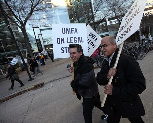 PHIL HOSSACK / WINNIPEG FREE PRESS - UMFA picketers march along McDermot ave in front of the Brodie Centre at the Bannatyne Campus at the Health Sciences Center Monday afternoon as the union and U of M administration continue to negotiate.  With the strike in it's 2nd week the picket line here is not blocking or delaying vehicular traffic or pedestrian, just seems to be maintaining a visible presence. See story.  November 7, 2016