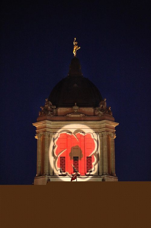 PHIL HOSSACK / WINNIPEG FREE PRESS - A Rememberance Day Poppy made it's appearance projected onto the top of Manitoba's Legislature Monday evening. STAND-UP  November 7, 2016