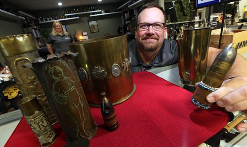 PHIL HOSSACK / WINNIPEG FREE PRESS - Marway Militaria, specializes in military memorabilia See Bill Redekop's tale. Jim Domanski, Jaime Cline's husband (she's watching rear) shows off "Trench Art" shell casings with carvings made in WW1 trenches and later as therapy for recovering wounds.  November 8, 2016