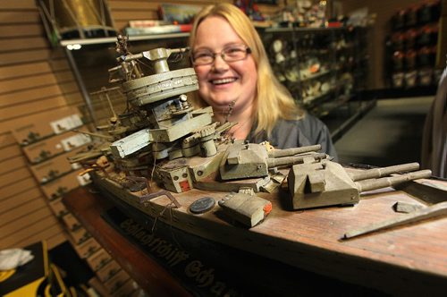 PHIL HOSSACK / WINNIPEG FREE PRESS - Marway Militaria, specializes in military memorabilia See Bill Redekop's tale. Jaime Cline shows off a carved model of the German Battle Cruiser Scharnhorst, carved by a German sailor in a POW camp at Red Lake Ontario.....  November 8, 2016