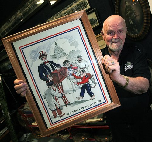 PHIL HOSSACK / WINNIPEG FREE PRESS - Marway Militaria, specializes in military memorabilia See Bill Redekop's tale. Wayne Cline shows off a WW2 propaganda poster featuring Hitler as a dancing monkey.  November 8, 2016
