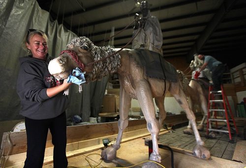 PHIL HOSSACK / WINNIPEG FREE PRESS -  Tracy Penner and Colin Chapnick dust off the camels carrying the three wise men Wednesday afternoon. The pair were prepping a float for this weekends Christmas Parade. While similar to the Three Camels that graced Great West Life for years these are new creations by JD Penner for the annual Santa Event. See Randy Turner's tale. November 9, 2016