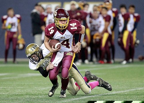 PHIL HOSSACK / WINNIPEG FREE PRESS -  Dryden Eagle #75 Koan Taylor hangs on the sack Portage Trojan Quarter Back #14 Tyler Morris Wednesday evening at the Inverstor's Field in playoff action. See Mike Sawatzky's story. November 9, 2016