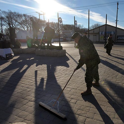 PHIL HOSSACK / WINNIPEG FREE PRESS -  Soldiers sweep up preparing for the Rememberance Day Ceremonies at Valour Road and Sargent. See story. November 11, 2016