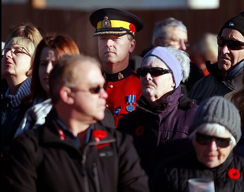 PHIL HOSSACK / WINNIPEG FREE PRESS -  Dressed in Serge, an RCMP Officer wears his poppy in his hatband at Valour Rd Friday morning. See story. November 11, 2016