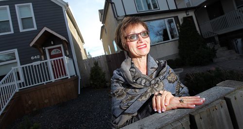 PHIL HOSSACK / WINNIPEG FREE PRESS -  Virginnia Lehotsky, ten years after her husband Harry died she's posing in front of a pair of his "Lazarus" homes rebuilt in the inner city. She lives in one, her son in the other.  See Kevin Rollason's story. November 11, 2016