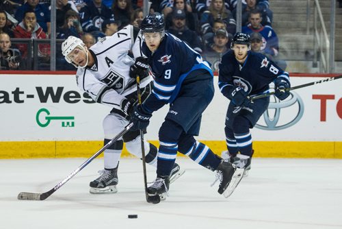 MIKE DEAL / WINNIPEG FREE PRESS
Winnipeg Jets' Andrew Copp (9) is knocked off the puck by Los Angeles Kings' Jeff Carter (77) during an afternoon NHL game at MTS Centre Sunday.
161113 - Sunday November 13, 2016