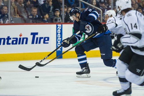 MIKE DEAL / WINNIPEG FREE PRESS
Winnipeg Jets' Jacob Trouba (8) keeps control of the puck slipping past Los Angeles Kings' Trevor Lewis (22) during an afternoon NHL game at MTS Centre Sunday.
161113 - Sunday November 13, 2016