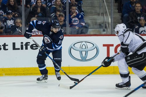 MIKE DEAL / WINNIPEG FREE PRESS
Winnipeg Jets' Nic Petan (19) and Los Angeles Kings' Tom Gilbert (14) during an afternoon NHL game at MTS Centre Sunday.
161113 - Sunday November 13, 2016