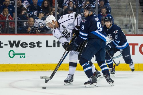 MIKE DEAL / WINNIPEG FREE PRESS
Winnipeg Jets' Andrew Copp (9) is knocked off the puck by Los Angeles Kings' Jeff Carter (77) during an afternoon NHL game at MTS Centre Sunday.
161113 - Sunday November 13, 2016