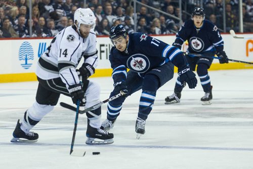 MIKE DEAL / WINNIPEG FREE PRESS
Winnipeg Jets' Adam Lowry (17) tries to knock Los Angeles Kings' Tom Gilbert (14) off the puck during an afternoon NHL game at MTS Centre Sunday.
161113 - Sunday November 13, 2016