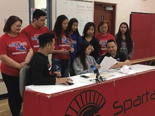 Canstar Community News Raizel Guinto (front row, middle, grey sweater) signs her official letter of intent to the Louisianna Tech University on Nov. 9, 2016.