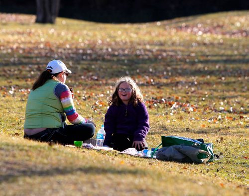 BORIS MINKEVICH / WINNIPEG FREE PRESS
WEATHER STANDUP - PICNIC - The Forks drew some exceptional weather seekers this afternoon. Danielle Epp, left, and her daughter Alexcis Epp, 8, right, took the day off school to have a girls day out at the Forks. They had a tough weekend with a family funeral and used the nice weather to relax. Nov 14, 2016