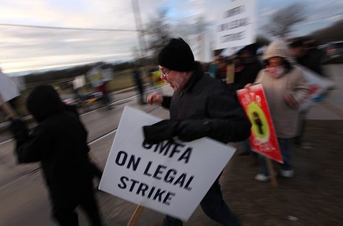 PHIL HOSSACK / WINNIPEG FREE PRESS -  Picketers march and wave to traffic manning a picket line at Univercity Cr and Markham Rd. See story re: strike into 3rd week.  November 14, 2016