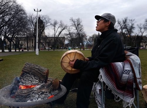 WAYNE GLOWACKI / WINNIPEG FREE PRESS

Shane Flett,17, from the Island Lake First Nation sings a song to strengthen his spirits after spending a cold night camped in Memorial Park across from the Manitoba Legislative Bld. He wants to bring awareness to the importance of Indigenous self governance and wants others to join him in the park and hopes to meet with provincial leaders. (His cell number is 1-204-558-0993 )  Nov. 16 2016