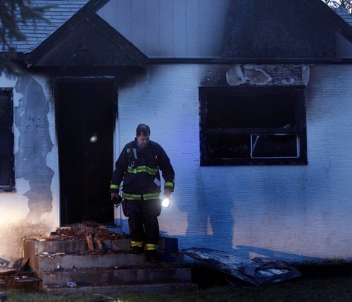 WAYNE GLOWACKI / WINNIPEG FREE PRESS

A Winnipeg Fire Fighter investigates the scene of a fire that heavily damaged a home in the 200 block of Lynbrook Drive in Charleswood Thursday morning.   Nov. 17 2016