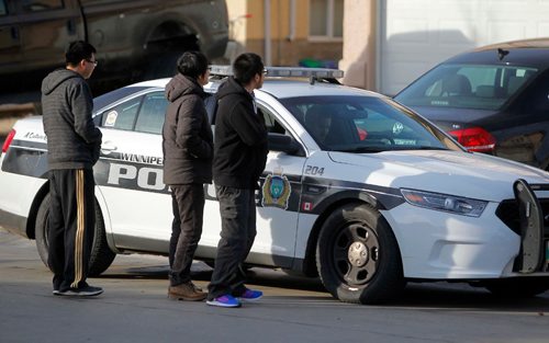 BORIS MINKEVICH / WINNIPEG FREE PRESS
67 Kinlock Lane, police scene regarding 2 males in medical distress. Possible overdose. These three men came out from a couple of doors down to ask police some questions. Nov 21, 2016