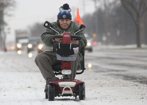 JOE BRYKSA / WINNIPEG FREE PRESS Antonio Vangesita  rides his scooter in the snow on Roblin Blvd  Tuesday morning-Nov 22, 2016 -( Standup photo)