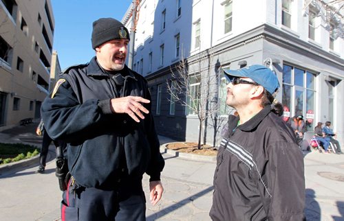 BORIS MINKEVICH / WINNIPEG FREE PRESS
MAIN STREET BEAT COP - Policeman Kevin Burkett, left, walks the beat down on Main Street near Henry Ave. Here he interacts with a man named Chuck, right, who frequents the area. Jen Zoratti story. Nov 15, 2016