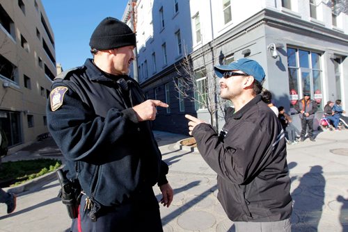BORIS MINKEVICH / WINNIPEG FREE PRESS
MAIN STREET BEAT COP - Policeman Kevin Burkett, left, walks the beat down on Main Street near Henry Ave. Here he interacts with a man named Chuck, right, who frequents the area. Jen Zoratti story. Nov 15, 2016