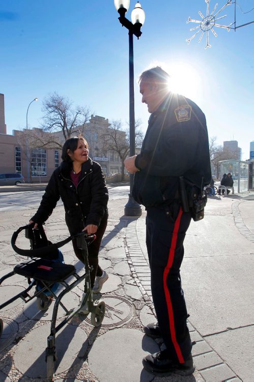 BORIS MINKEVICH / WINNIPEG FREE PRESS
MAIN STREET BEAT COP - Policeman Kevin Burkett, right, walks the beat down on Main Street near Henry Ave. Here he interacts with a woman named Caroline, left,  who frequents the area. Jen Zoratti story. Nov 15, 2016