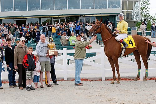 BORIS MINKEVICH / WINNIPEG FREE PRESS  080615 Horse #4 Ronaldino wins the Free Press race at the downs. The favored horse #7 Lookinforthesecret came second. WINNERS CIRCLE PHOTOS.