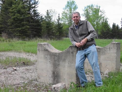 Author Ed Stozek leans on the foundation of the power house at the former POW camp.
photo by Bill Redekop / Winnipeg Free Press