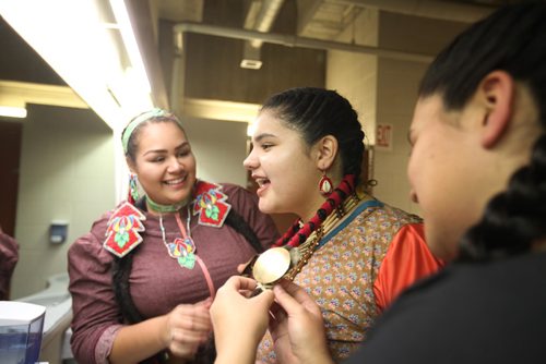 
RUTH BONNEVILLE / WINNIPEG FREE PRESS

Jingle dress dancers Autumn Monkman (left), Iroc Levasseur (centre) and Ainsley Clarke help Levasseur   with her costume in the washroom at the U of W as they prepare to perform in a round dance during half time for  the Canada West Basketball tournament at the U of W Dr. David F. Anderson Gymnasium Thursday.  
Standup 
November 24, 2016