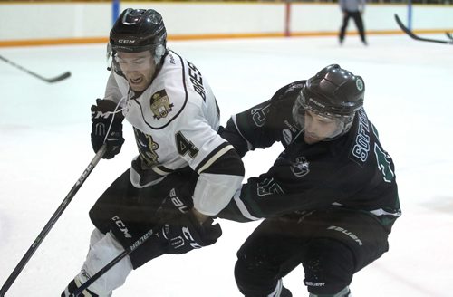 
RUTH BONNEVILLE / WINNIPEG FREE PRESS

Bison's player #4 Channing Bresciani wrestles to keep control of the puck and fend off Huskies  #15 Michael Sofillas during game at Max Bell  Friday night.
Sports Standup 

November 24, 2016