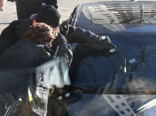 RUTH BONNEVILLE / WINNIPEG FREE PRESS

Police Identification officers investigate shooting scene on  Stradbrook Ave where 6 shot were fired at a vehicle around 3am Saturday morning sending two people to the hospital.  Bullet holes can be seen windshield. edit: victim is Theodoros Belayneh

Nov 26, 2016
