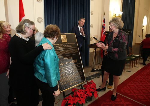RUTH BONNEVILLE / WINNIPEG FREE PRESS
Premier Brian Pallister, Lieutenant Governor of Manitoba Janice Filmon and The Nellie McClung Foundation Board Chair Lila Goodspeed (left, green) as well as other members look at the official plaque commemorating the 100th Anniversary of some Manitoba women receiving the right to vote after it was unveiled at a ceremony at the Legislative BuildingTuesday.
Nov 29, 2016