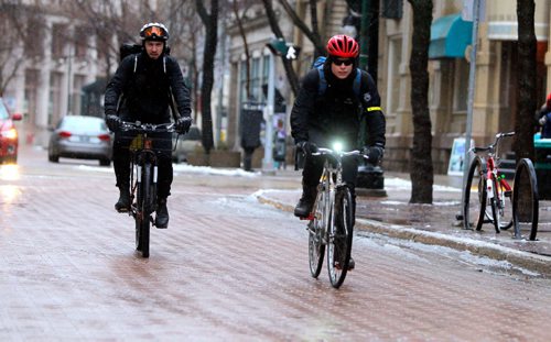 BORIS MINKEVICH / WINNIPEG FREE PRESS
Matt Veith, left, and Dan Russell, right, cycle through the exchange district on Albert Street Tuesday afternoon. Nov. 29, 2016